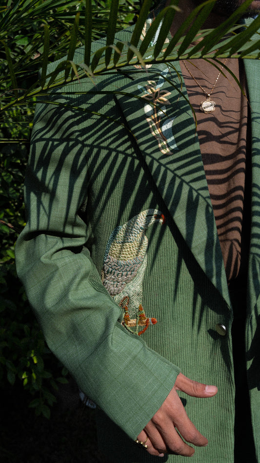 Made using a mix of cotton plaid and velvet green corduroy. Featuring an oversized single breasted notch lapel silhouette and straight leg pants.