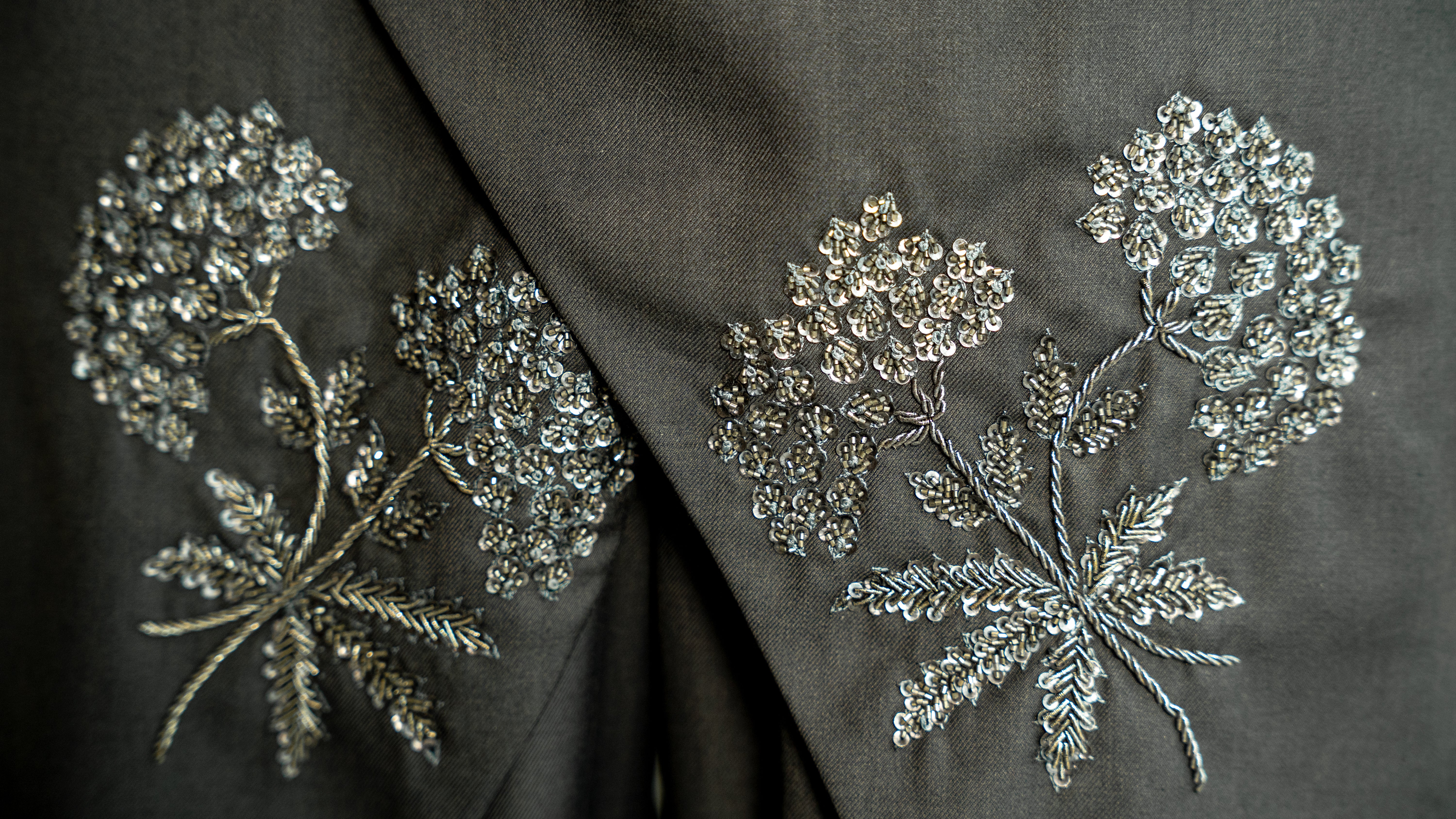 Decorative floral embroidery on a dark fabric background